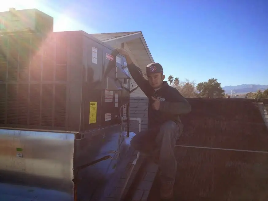 HVAC technician performing HVAC Inspection on a rooftop unit in Corvallis
